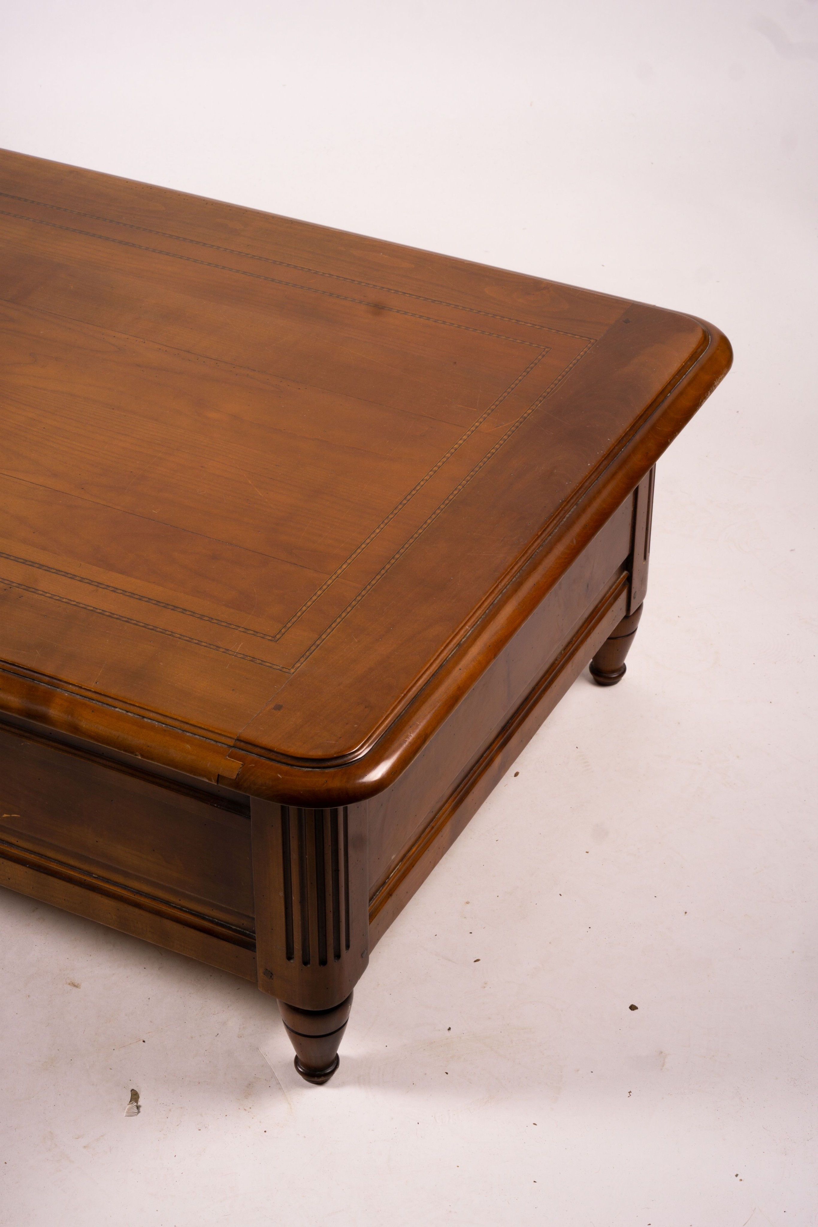 A reproduction rectangular walnut coffee table with rising top enclosing a wine bottle storage interior, length 130cm, depth 85cm, height 41cm